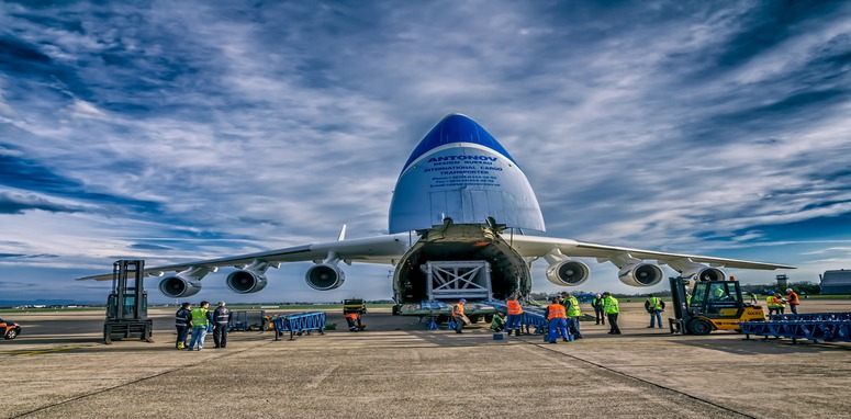as-air-cargo back of air plane being loaded with cargo