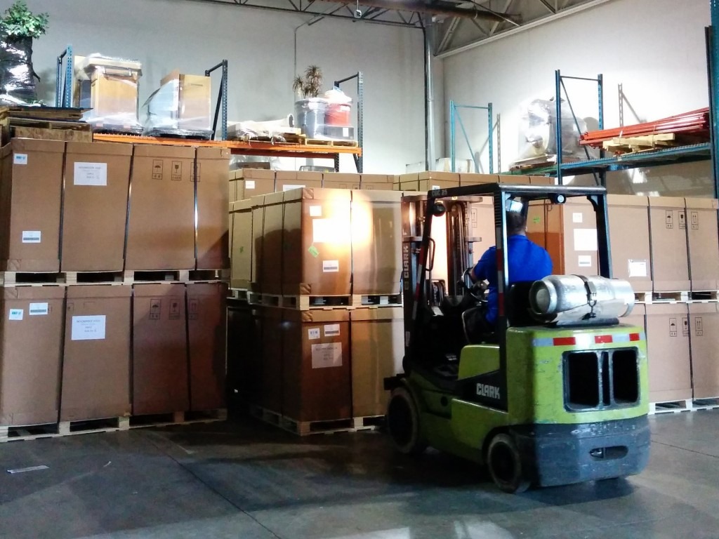 cost-production fork lift moving boxes on pallets
